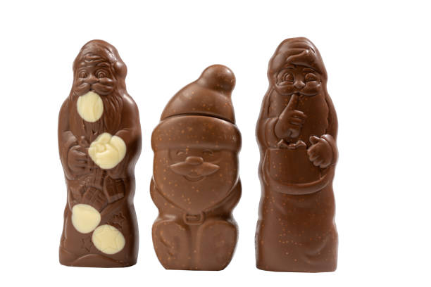 istock Three chocolate figures of Santa Claus, one holding a bag 2188877448