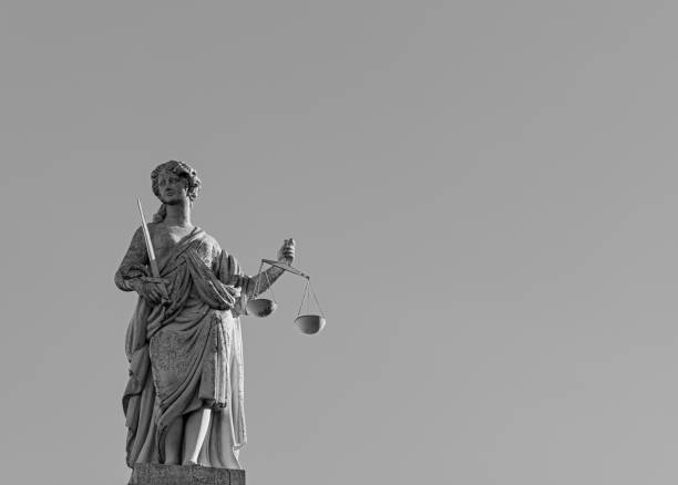 istock Justitia sculpture against clear sky 2188878019