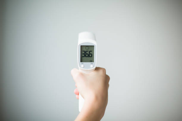 istock Digital Thermometer in Hands Showing 36.6 Temperature 2188878754