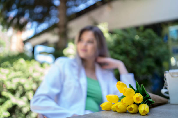 Surprise at 8 march, International Women's Day. Girl smiling and holding a bouquet of yellow tulips. Surprised woman. Holiday greeting card for Valentine's, and Mother's Day. Spring flowers. Closeup.