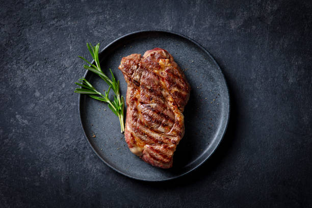 istock Beef Steak medium rare on a black plate. Dark background. Close up. Top view. 2188882620