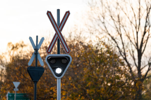 istock Railway crossing signal with flashing light in autumn setting 2188882662