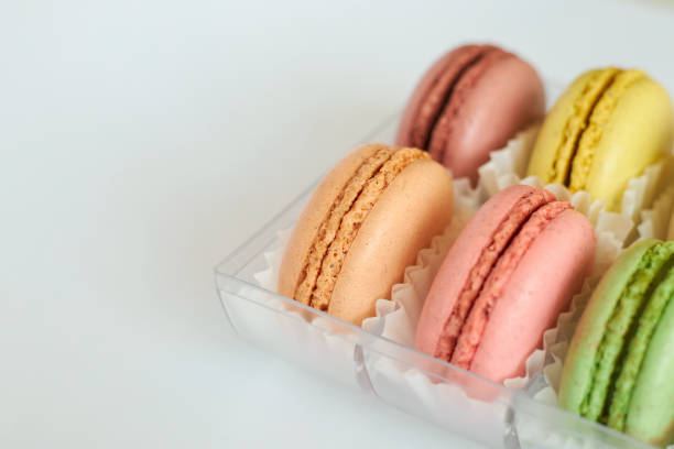 istock delicate colorful cakes French Macarons with white paperpan in plastic box 2188882685
