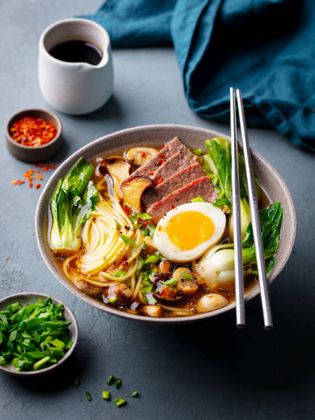 istock Asian noodle soup, ramen with beef, vegetables and egg in bowl. Grey background. Close up. 2188883601