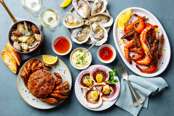 Top view of raw fishes with spices on table. Omega 3 food ingredients with raw mackerel fish, sardines , squid and spices for cooking.