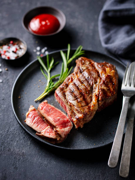 istock Beef Steak medium rare on a black plate. Dark grey background. Close up. 2188884240