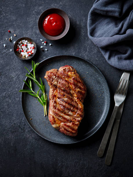 istock Beef Steak medium rare on a black plate. Dark background. Top view. 2188884324