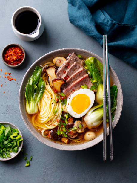 istock Soup Ramen with beef, vegetables and egg in bowl. Grey background. Top view. 2188884919