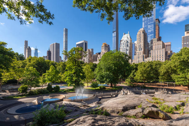istock Summer Morning in Central Park with granite rock formations and water feature playground. View of Billionaires' Row supertall skyscrapers. Midtown Manhattan, New York City 2188887160