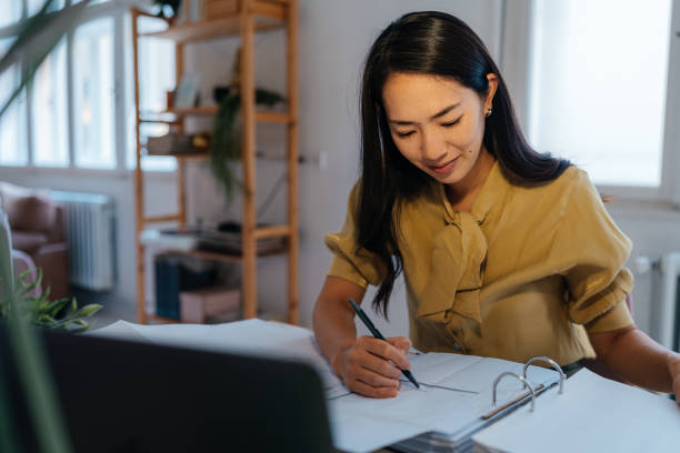 istock Professional Businesswoman Reviewing Documents in a Modern Office Setting 2188887917