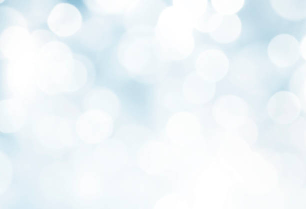 istock Glowing lights Christmas holiday background, blue and white winter backdrop, illustration. Defocused festive banner.Snowy texture, 2188892990