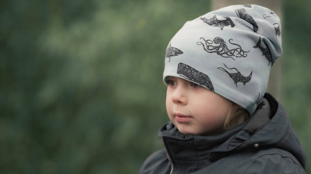 istock Young Child in Winter Hat With Nautical Design in Outdoor Setting 2188893204