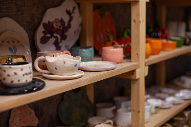 istock Shelf with handmade clay cups and plates at pottery studio. 2188893251