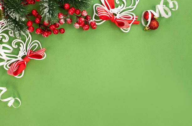 istock Christmas decor on green background top view. Red white decorations, winter holiday backdrop.Empty space festive card, border. 2188895136