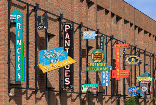 Edmonton, Alberta, Canada - September 22, 2024: Neon signs displayed on outside brick wall of the Neon Sign Museum at 104 St NW in downtown Edmonton