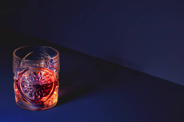 istock Exquisite Elegant Crystal Glass Adorned with Amber Reflections Set on a Deep Blue Background 2188900821