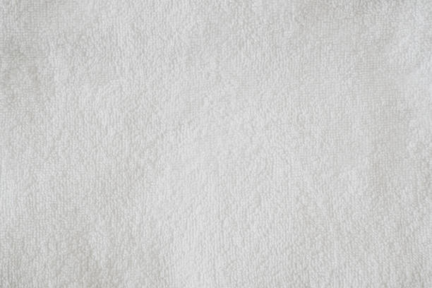 Texture of clean white fluffy cotton towel, top view