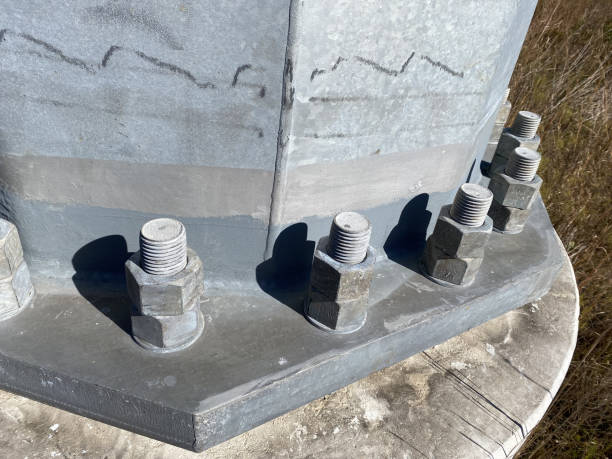 istock View from above of pylon base bolted to concrete base with two nuts per bolt 2188903665