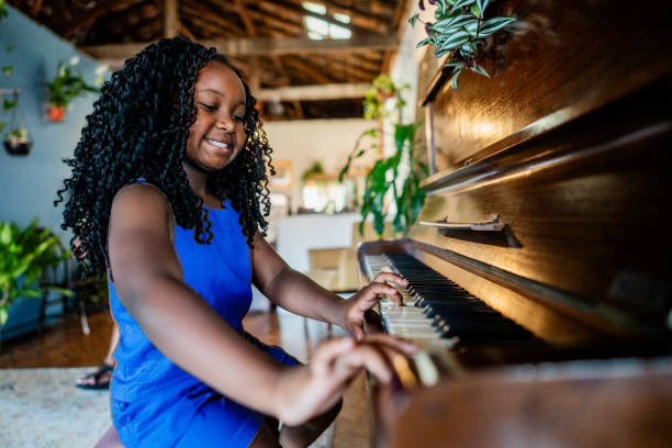 istock Girl playing piano at home 2188904367