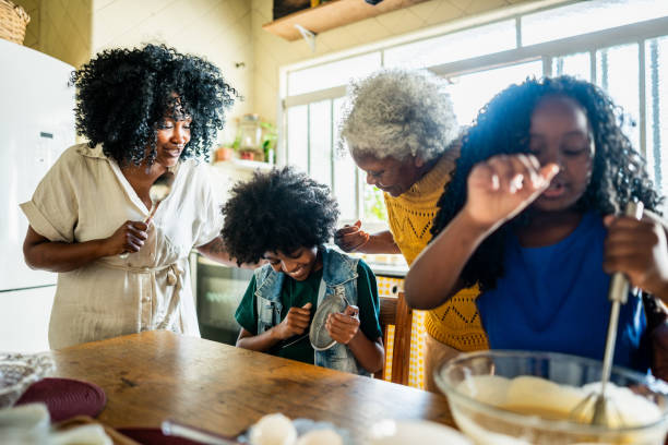 Family singing and dancing while baking at home