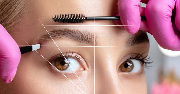 permanent make-up for eyebrows of beautiful woman in beauty salon. closeup beautician doing eyebrows tattooing. collage before and after the procedure. - アイブロウ ストックフォトと画像