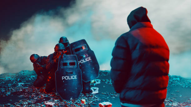 Tense standoff between a lone figure in a hooded jacket and a group of heavily armed police officers equipped with riot shields and tactical gear. The officers are crouched defensively amidst a debris-strewn area, with smoke or fog creating a dramatic and suspenseful backdrop. The red and blue lighting adds an intense, cinematic feel, highlighting the contrast between the solitary figure and the law enforcement team.