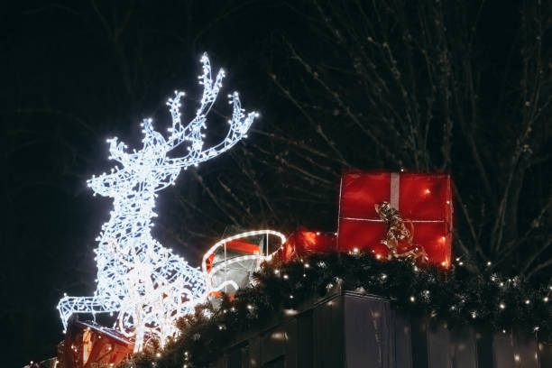 istock Decorative holiday display featuring illuminated reindeer and presents at night 2188910083