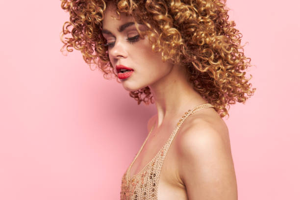 Model Evening makeup dress romance curly hair pink background