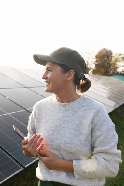 istock Female farmer with digital tablet on a modern farm using solar panels 2188911559
