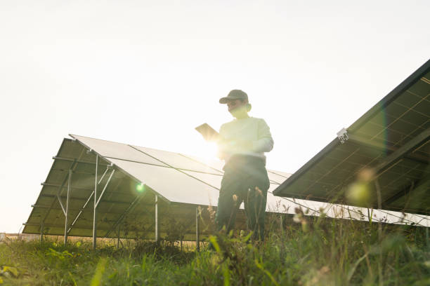 istock Female farmer with digital tablet on a modern farm using solar panels 2188911954