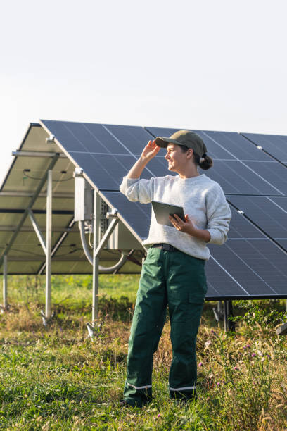 istock Female farmer with digital tablet on a modern farm using solar panels 2188913403