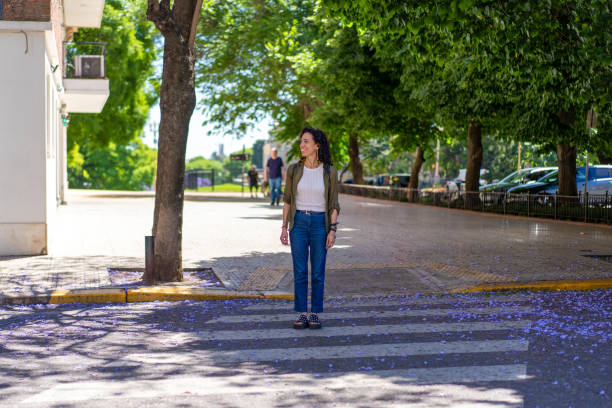 istock Confident woman standing on a crosswalk in a lively urban setting 2188914271