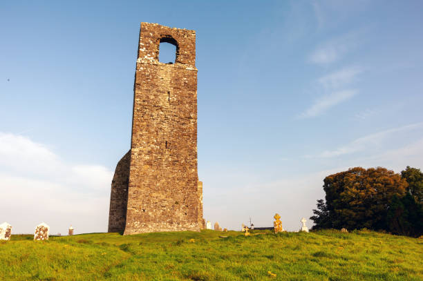 istock A tall tower with a small window sits on a grassy hill 2188915087