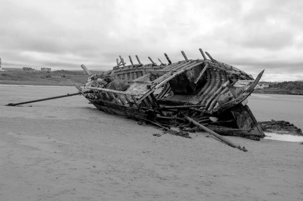 istock A large ship is laying on the beach, with its hull broken and its sails torn 2188918055