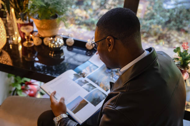 istock Man looking at a book in a cafe 2188920280
