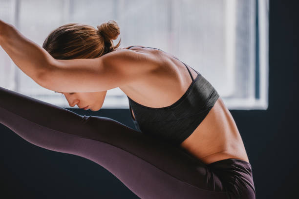 istock Focused Woman Practicing Yoga Pose in a Sunlit Studio 2188922817