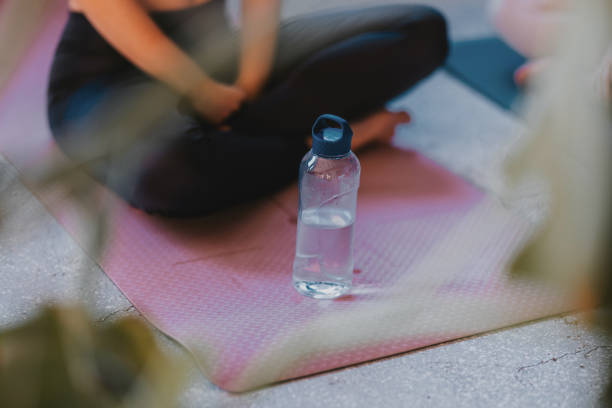 Hydration and Meditation on a Pink Yoga Mat with Water Bottle