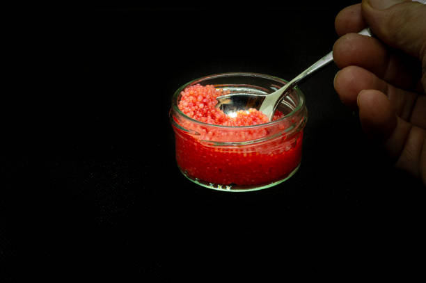 istock red lumpsucker roe in a glass jar against black background 2188926954