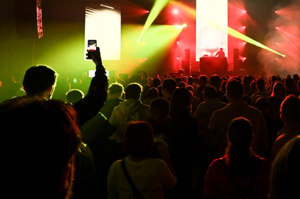 istock Audience cheering at concert and a party 2188927962