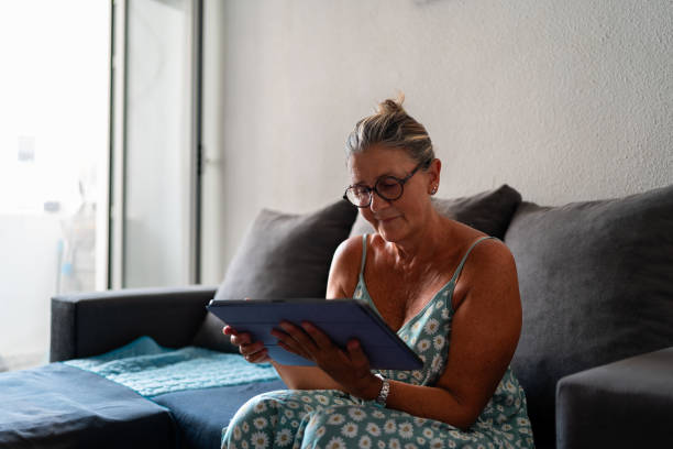 istock Senior woman working from home on digital tablet 2188928827