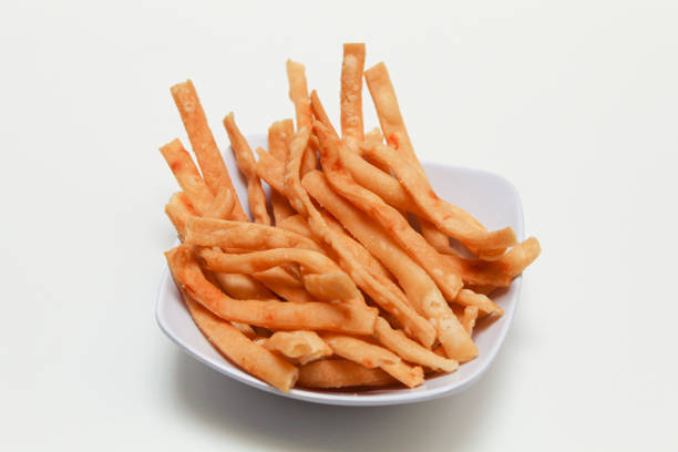 Cheese stick snacks, in a white bowl, isolated on white background