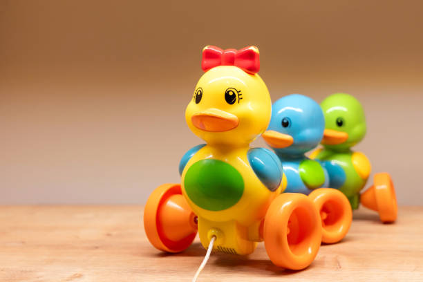 Colorful plastic pull toy features an adorable duck and two cute chicks, perfect for childrens play
