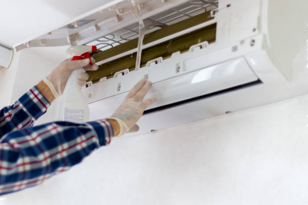 istock A technician cleaning and maintaining air condition unit. 2188930927