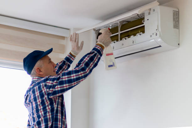 istock A technician cleaning and maintaining air condition unit. 2188930929