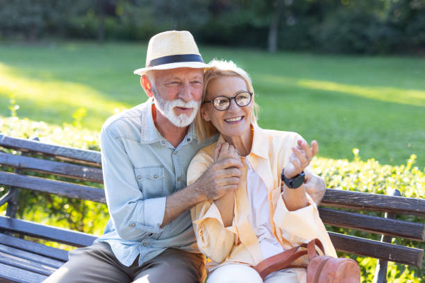 istock Smiling senior couple enjoying peaceful moment on park bench 2188932476