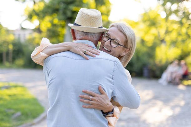 istock Elderly couple embracing affectionately in a picturesque park 2188932486