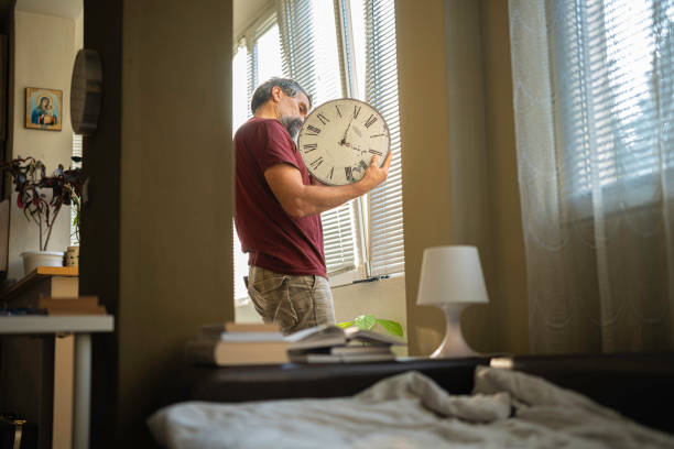 Man Changing Batteries on Wall Clock. Chores