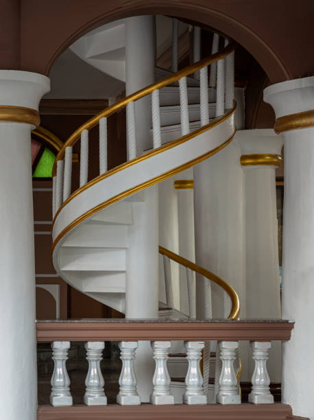 An indoor spiral staircase with a view from below