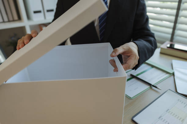 istock An office worker is putting important documents in boxes to prevent loss. A businessman is putting important work documents in a neat place. Documents and reports. 2188941968