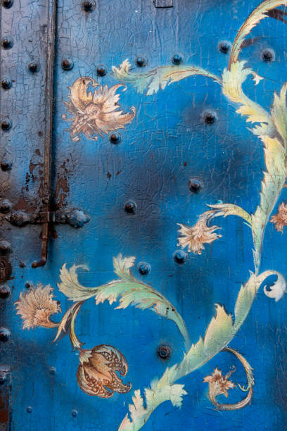 Blue gate, decorated with colorful runner flowers.